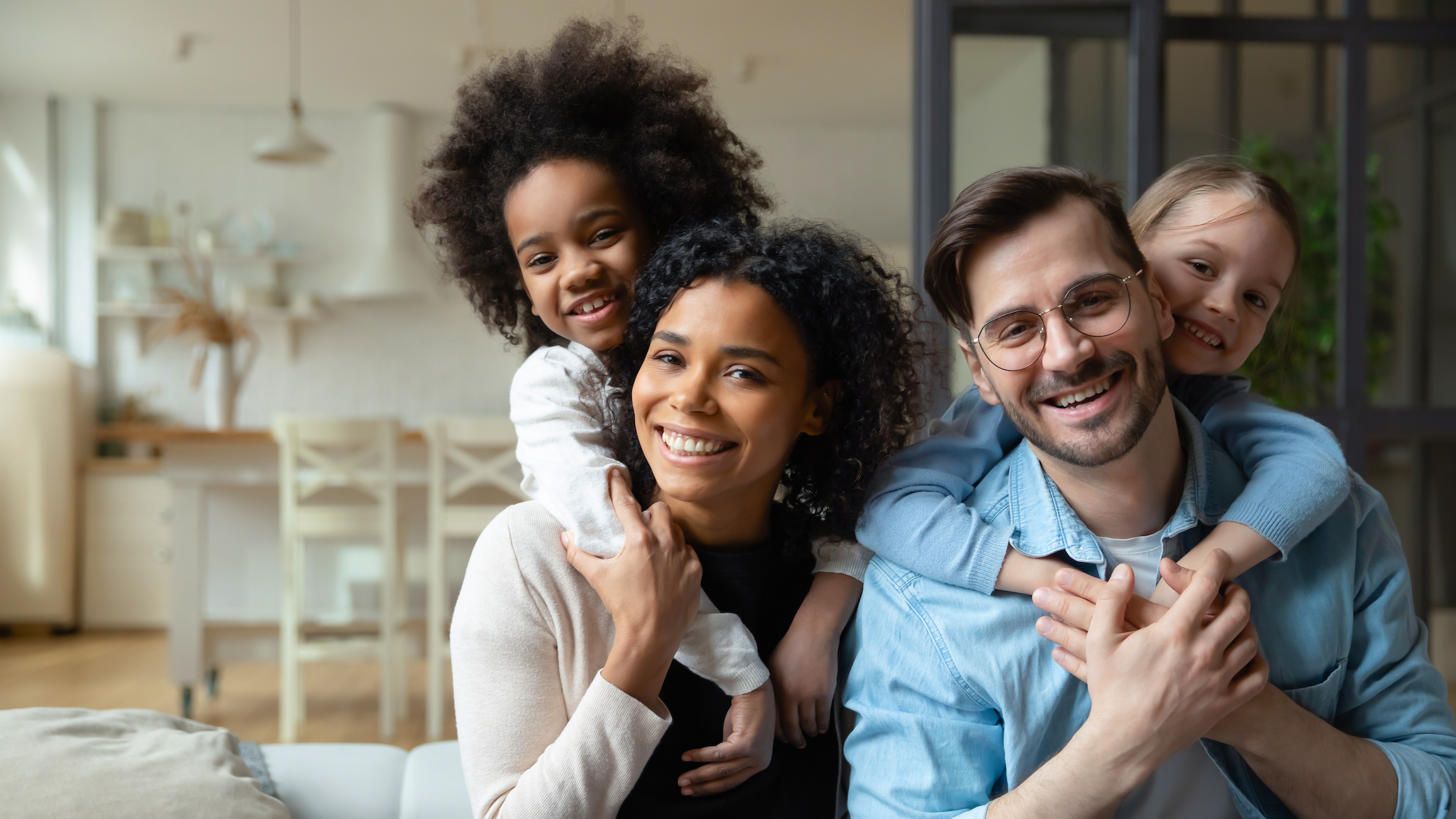 Multiracial couple with their two children at home