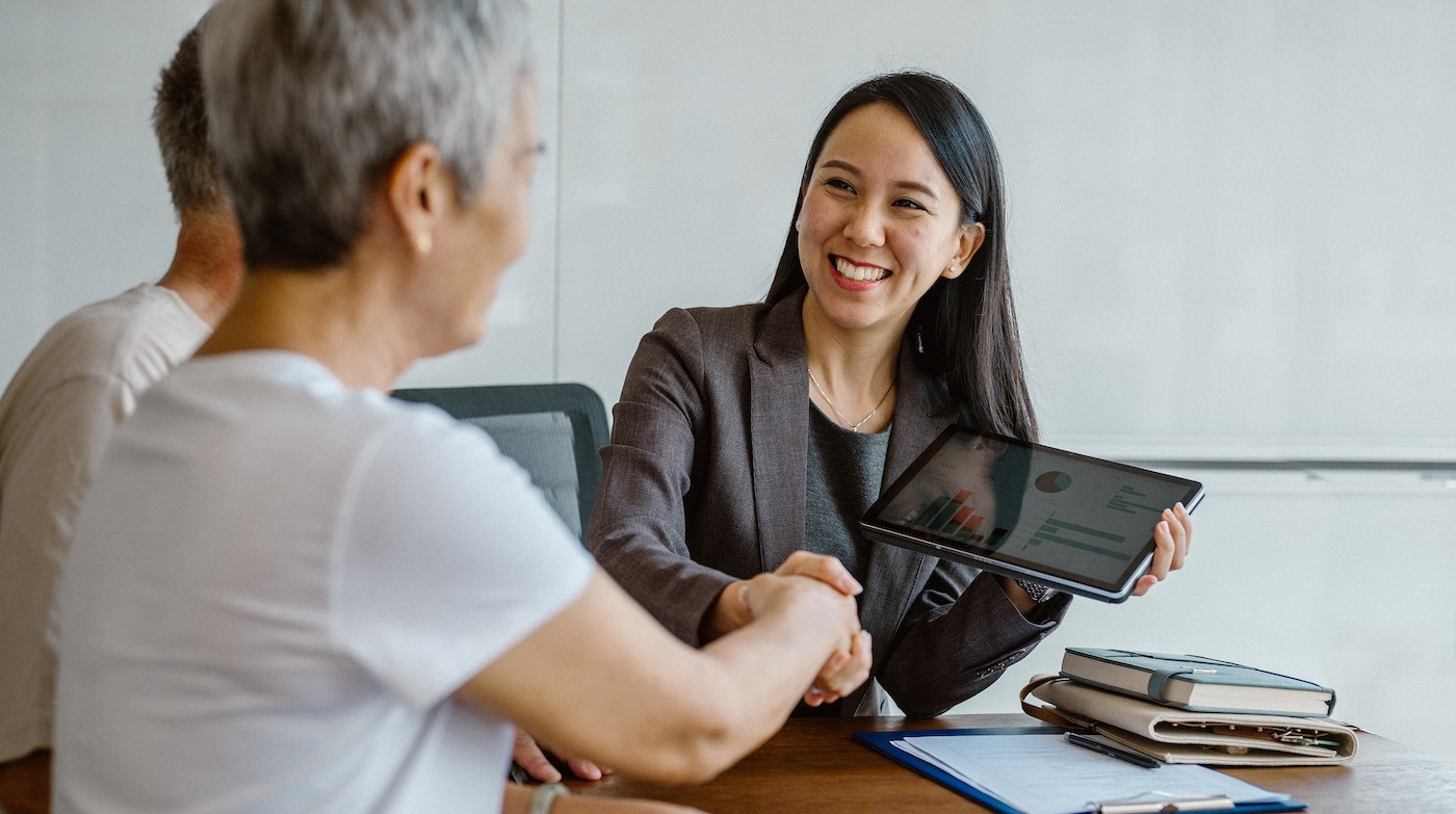 Woman shaking woman's hand in an office
