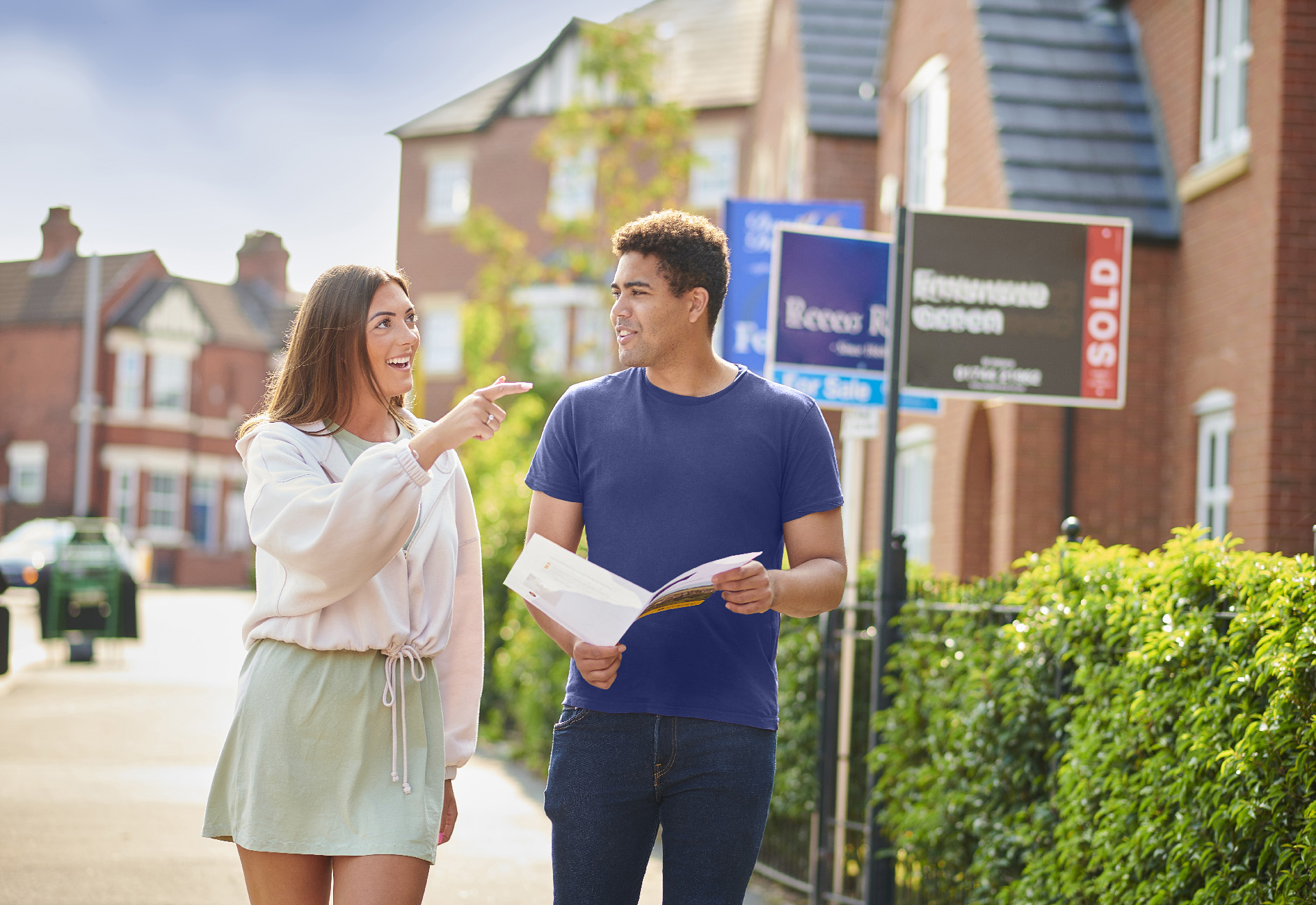 Couple walking on the street and looking for properties