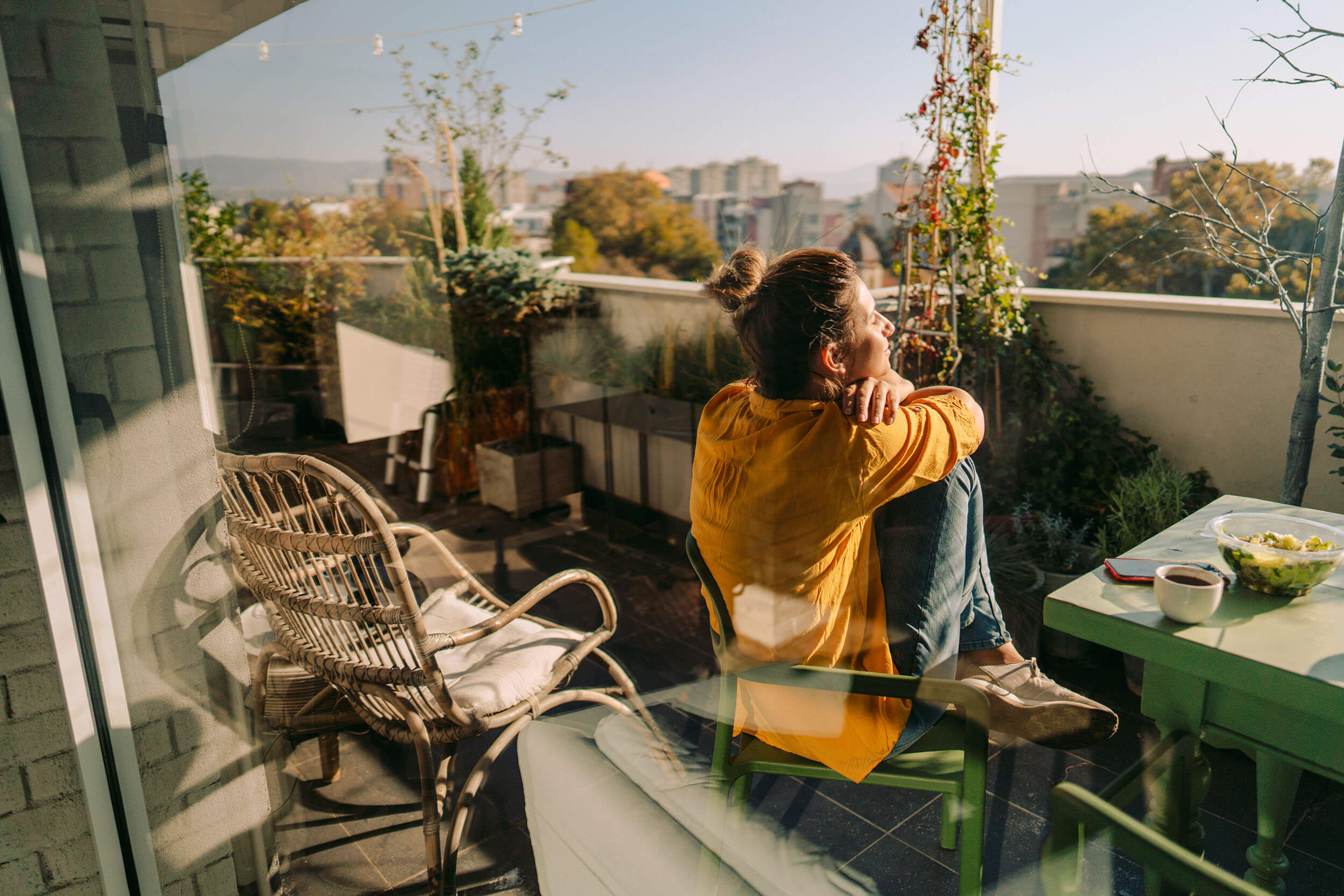 A woman sitting on a chair on a balcony