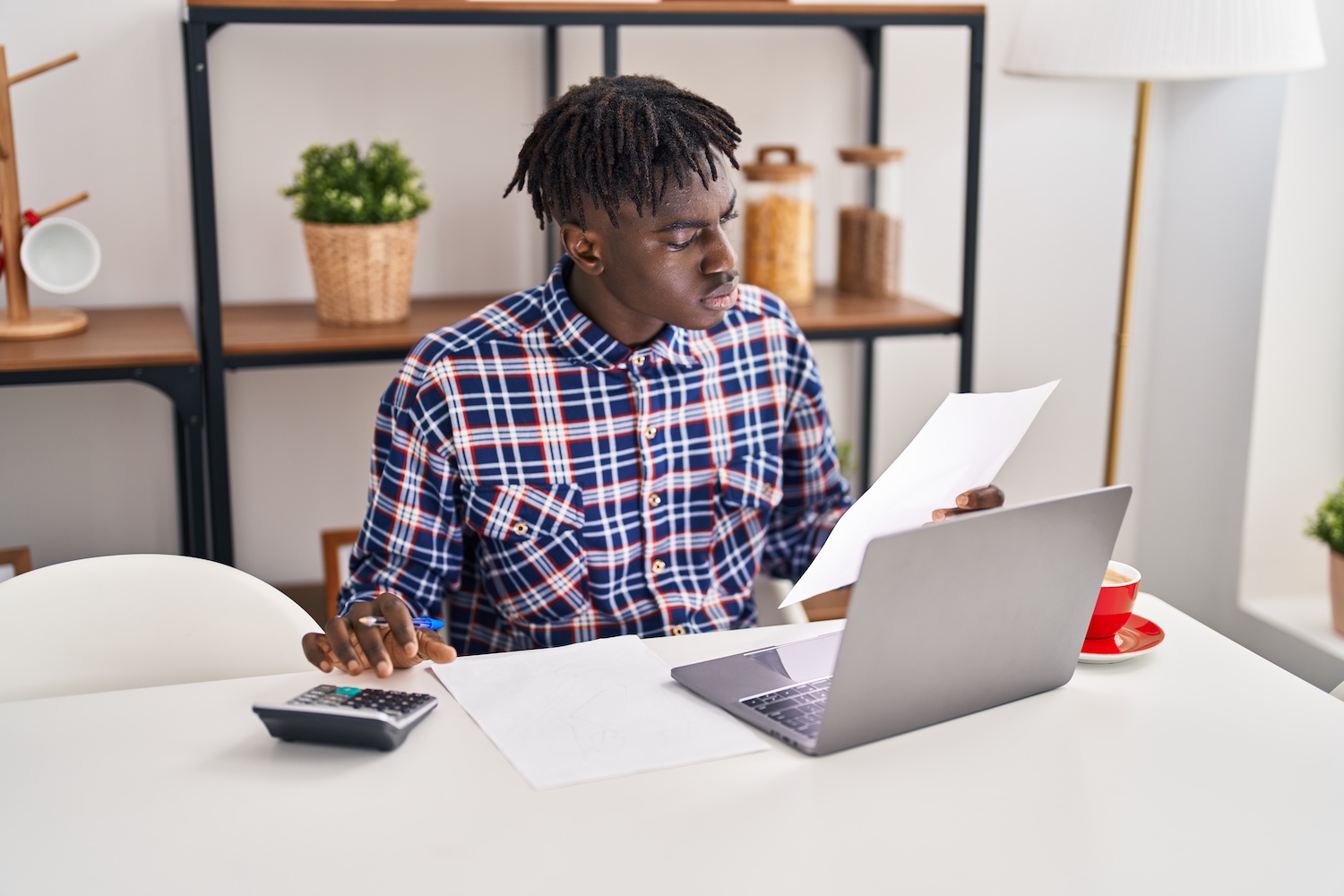 Man on a desk with laptop looking at documents