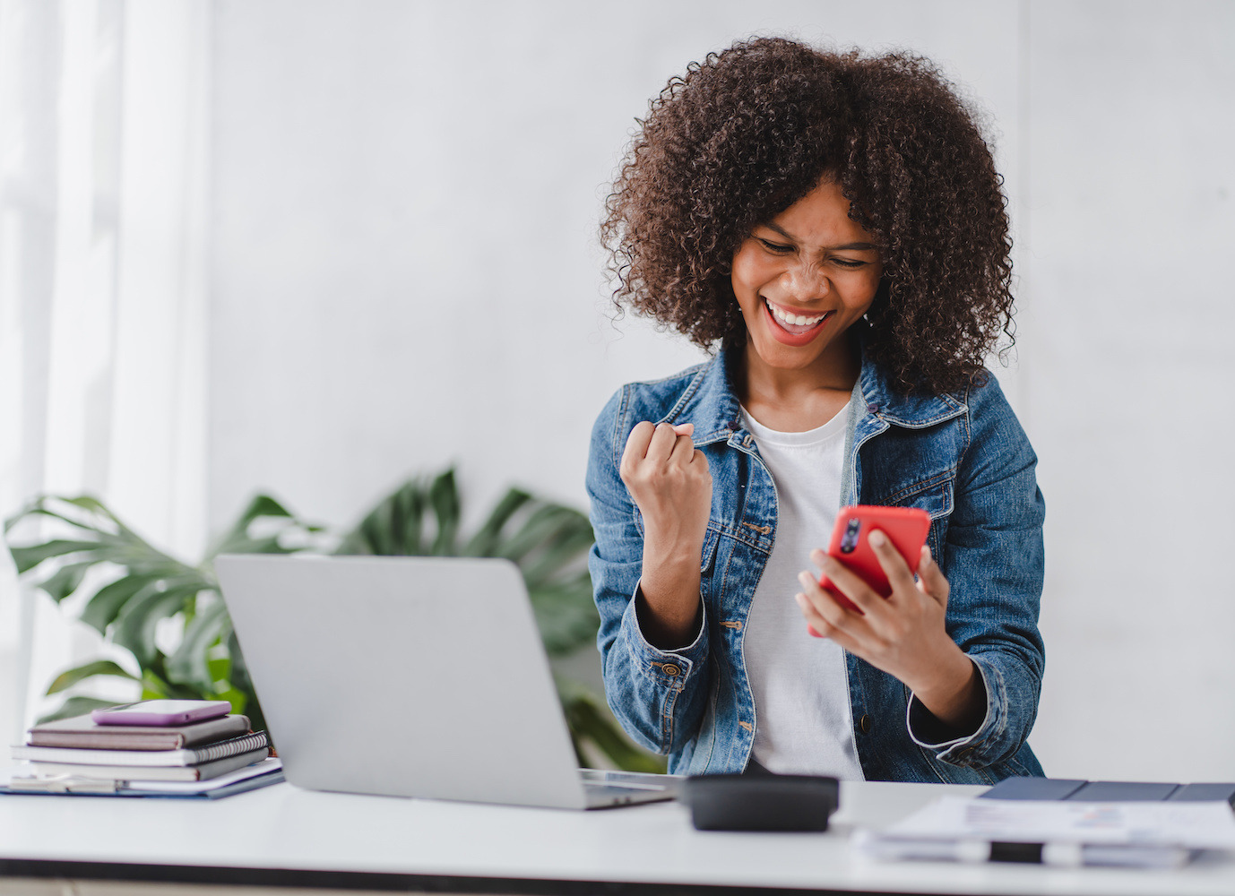 Excited woman looking at her phone