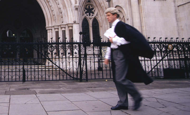 Barrister walking in front of a building