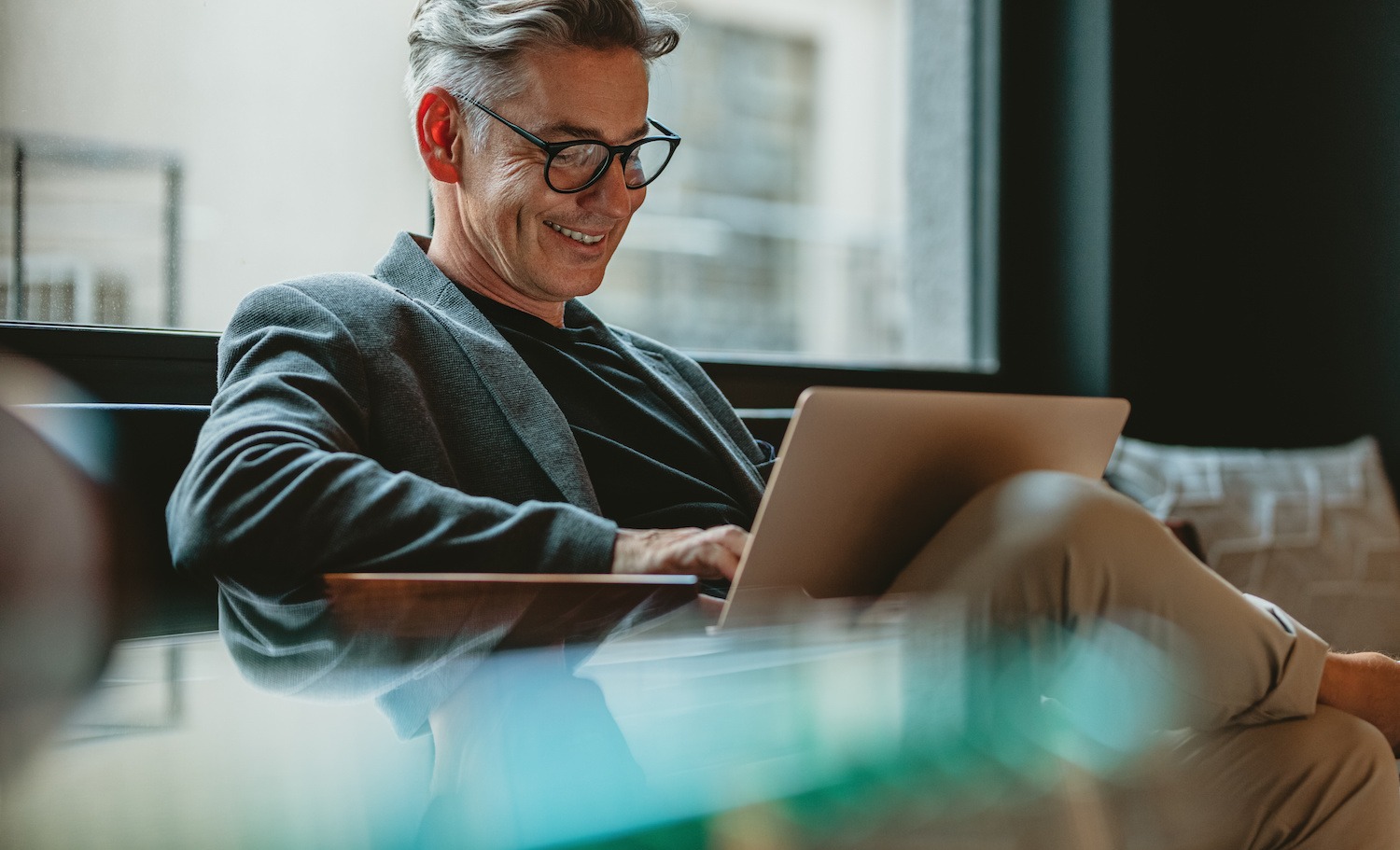 Business professional working on laptop in office lobby