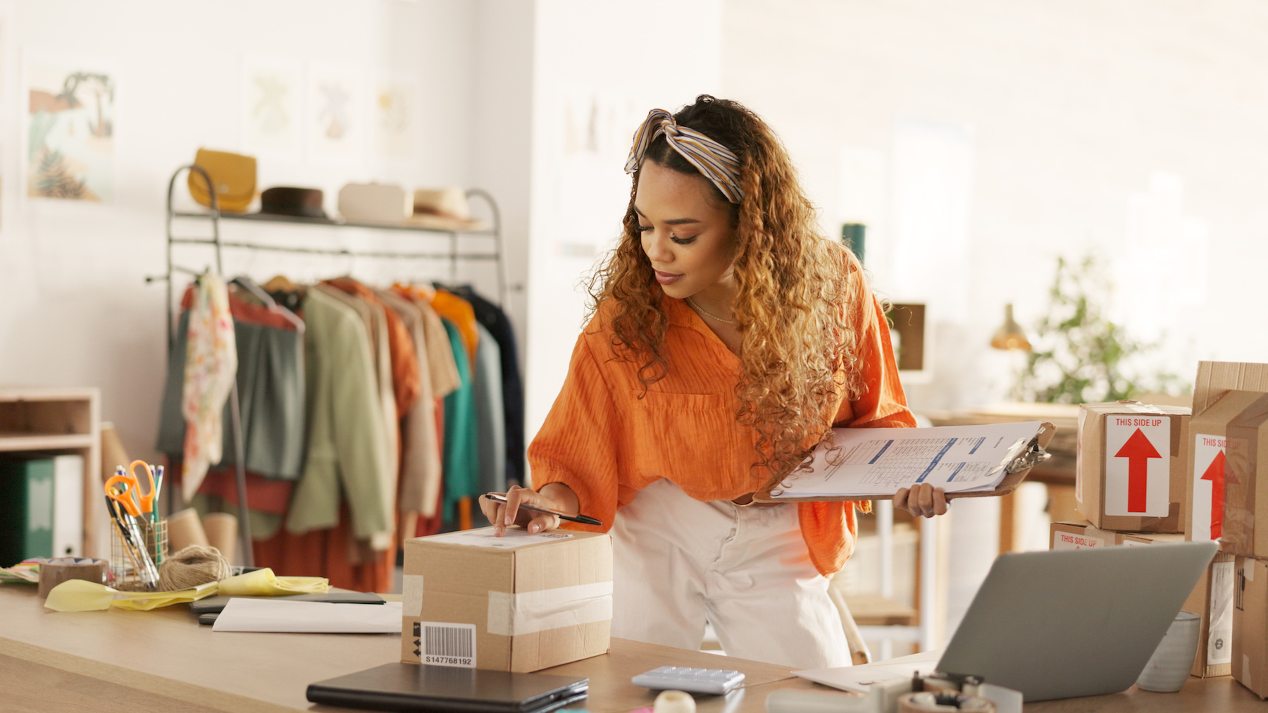 Businesswoman preparing a package for delivery