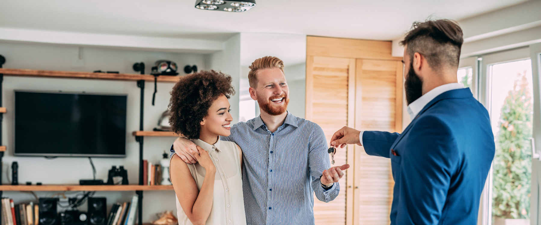 Broker giving house keys to a couple