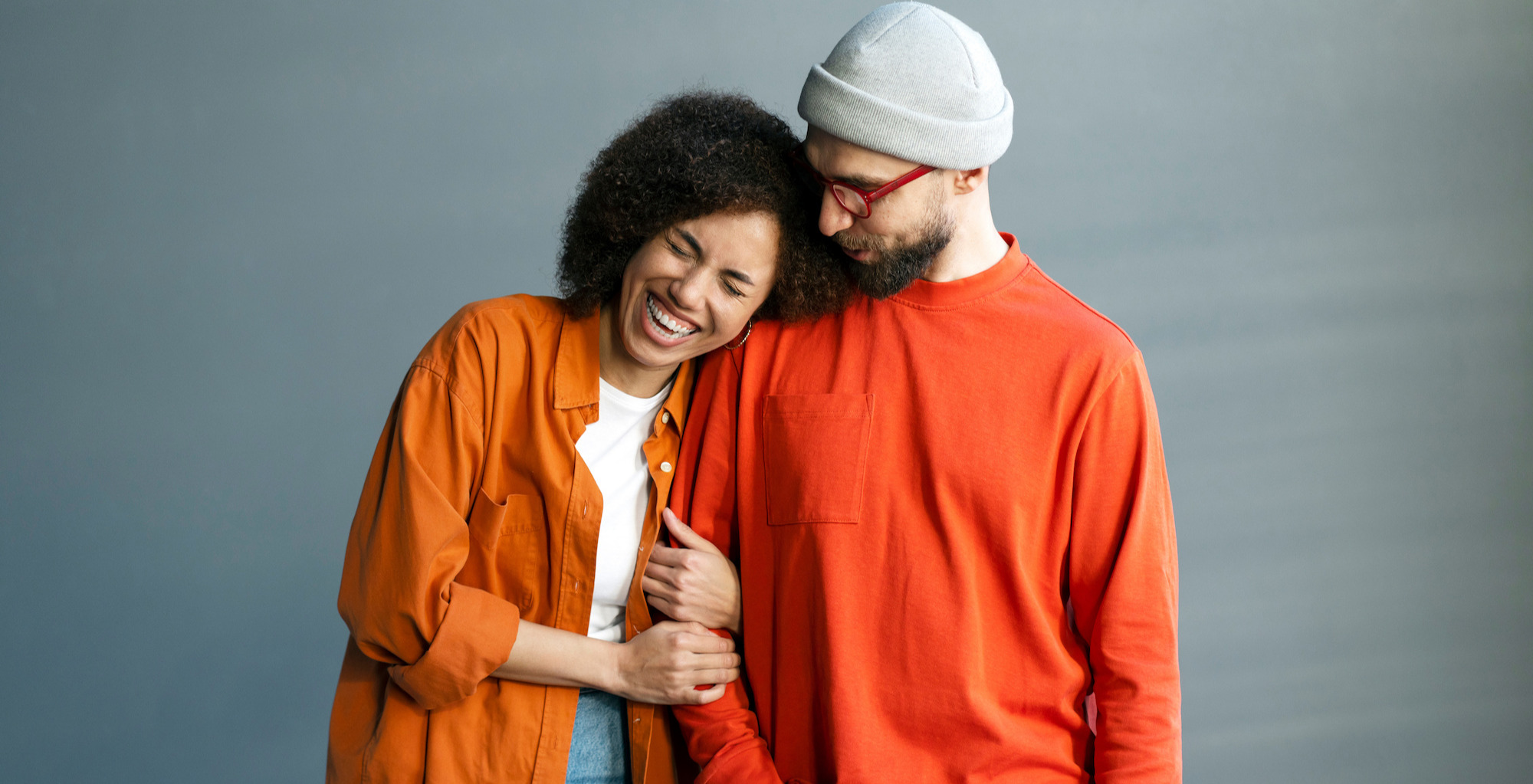 Laughing woman holding a man's hand