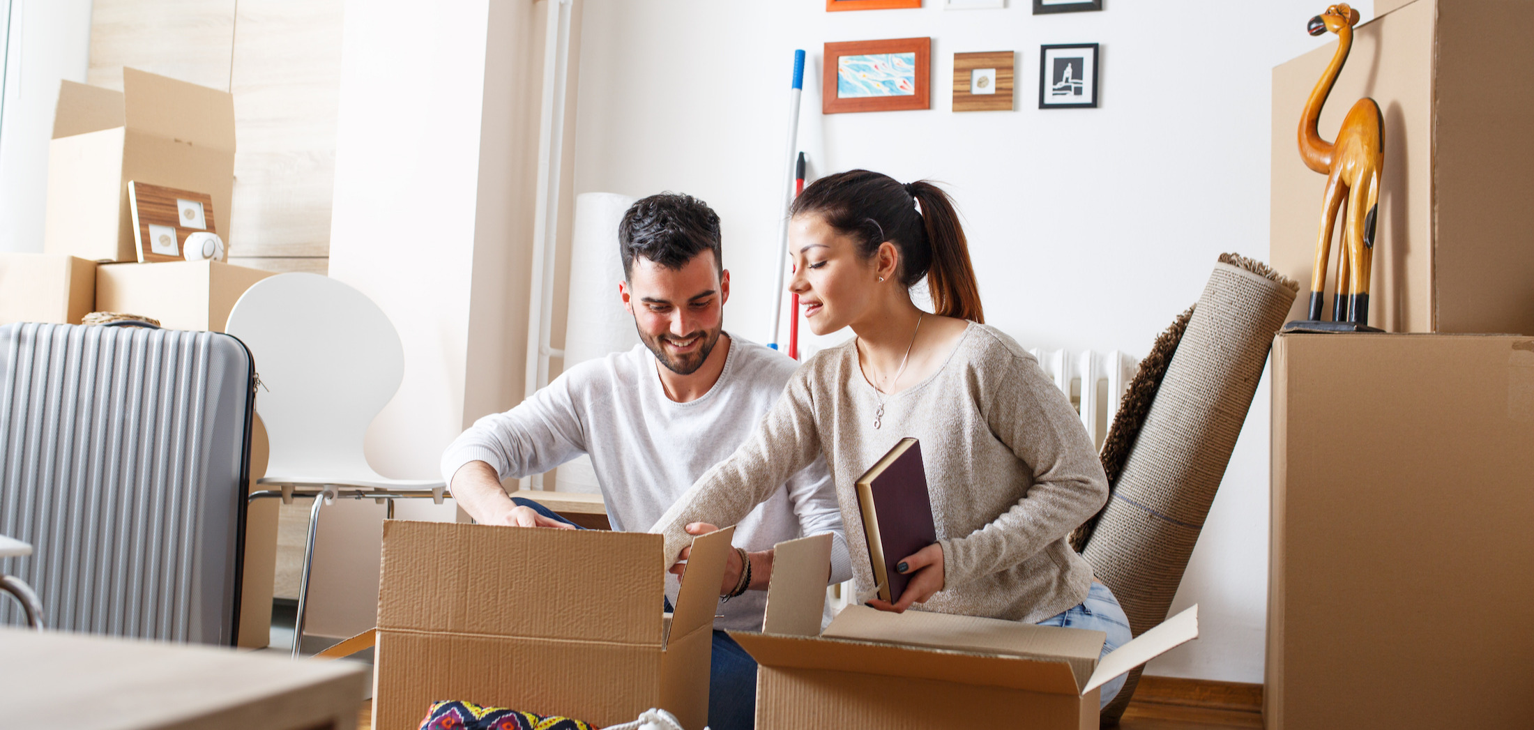 A couple going through boxes in a new home