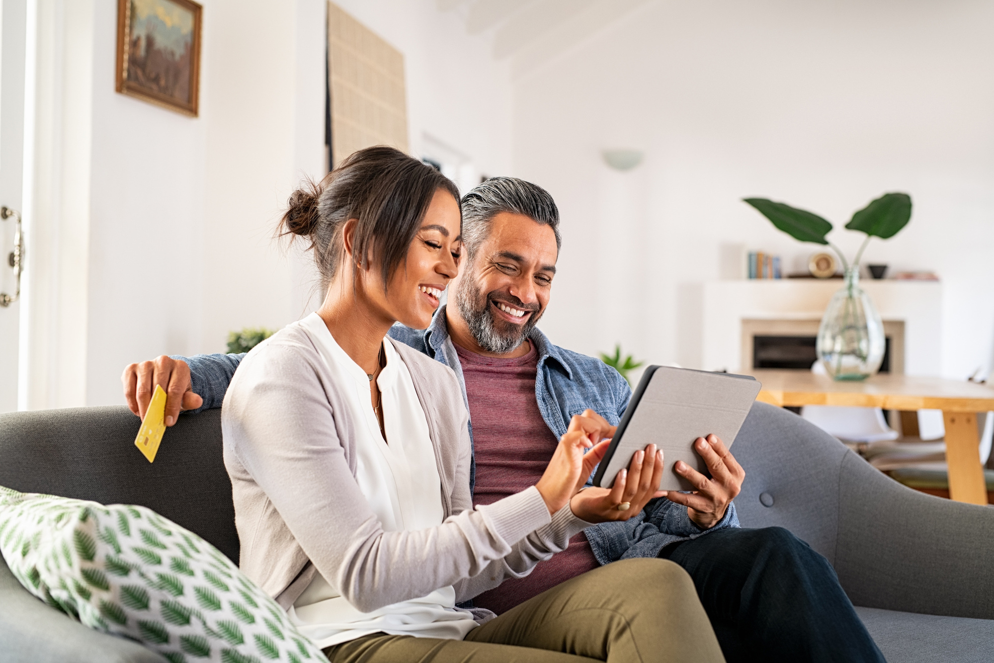 Couple looking at a tablet in a living room