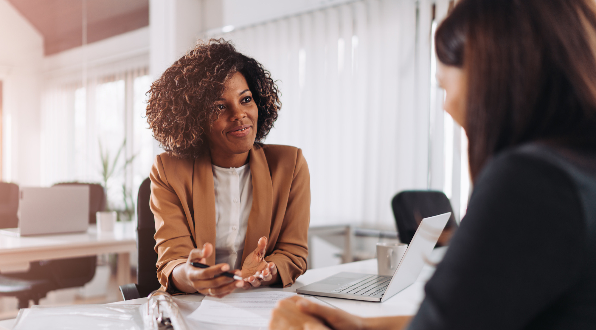 Two women having a discussion in an office