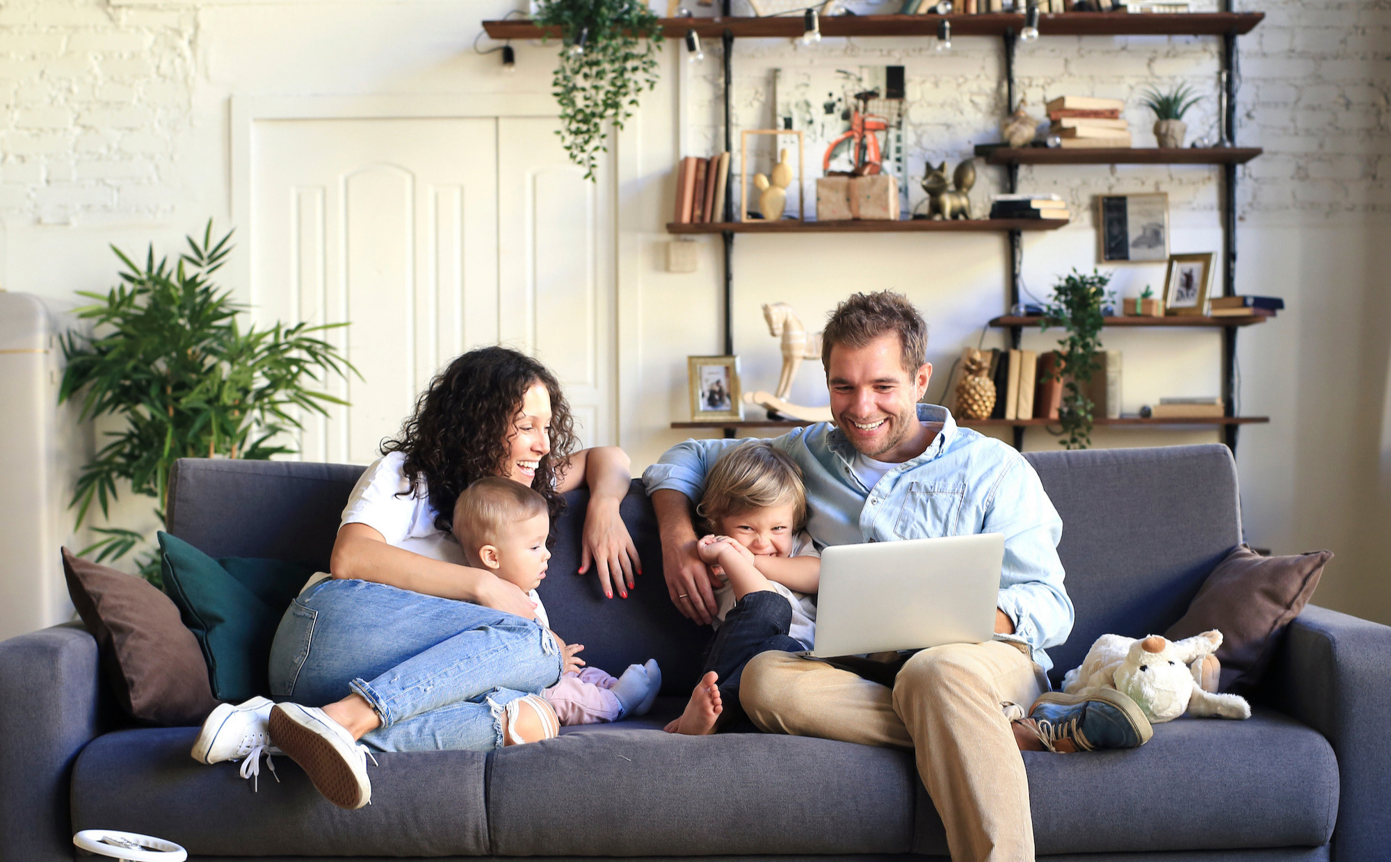 Family with two children sitting on a sofa