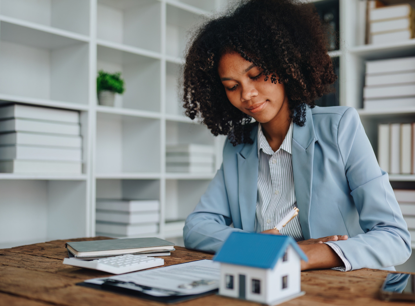 Woman signing a document in an office