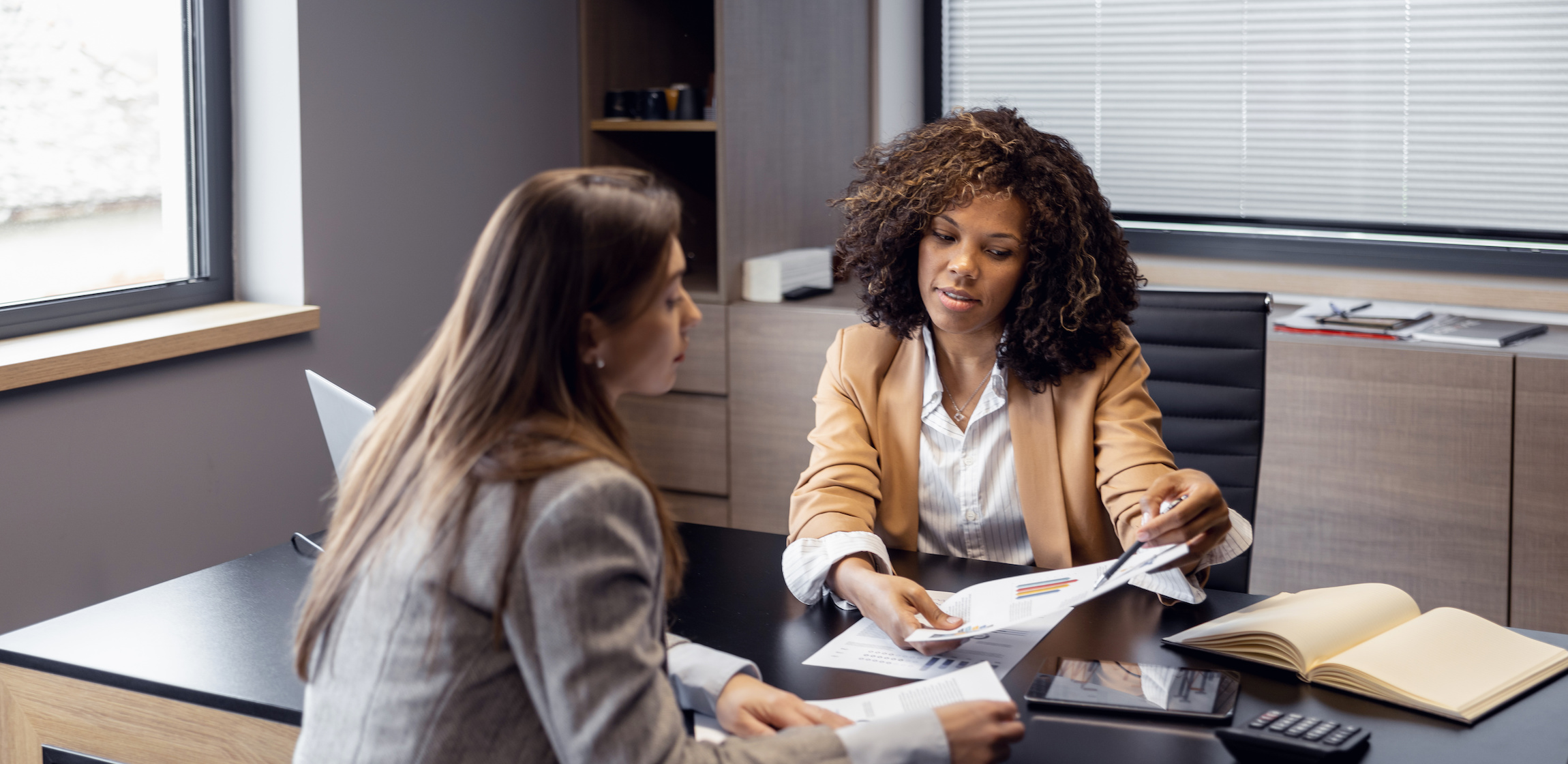 Two business women talking in an office