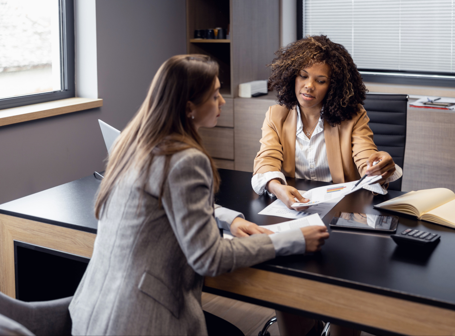 Two business women talking in an office