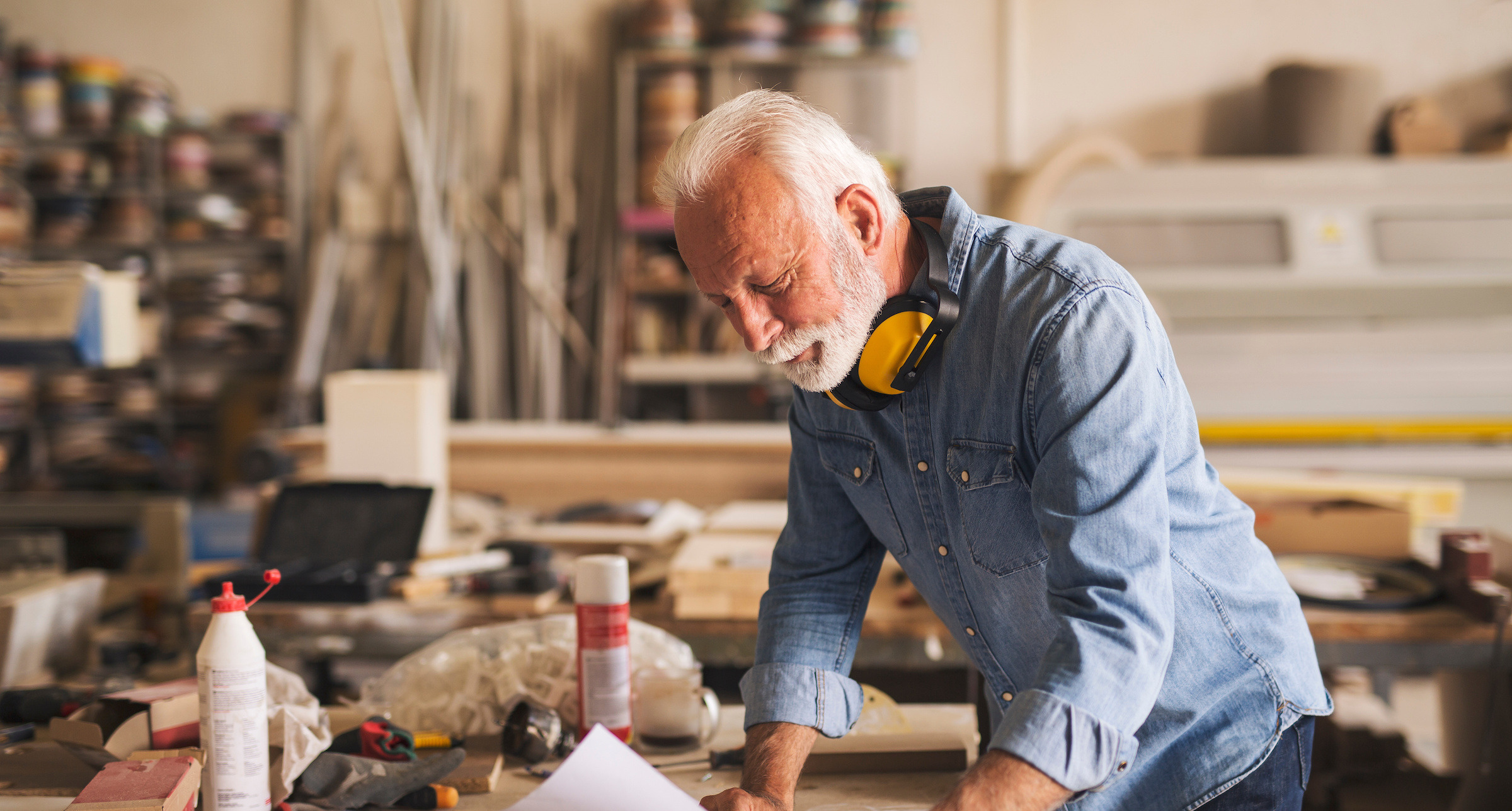 A carpenter reading project blueprints