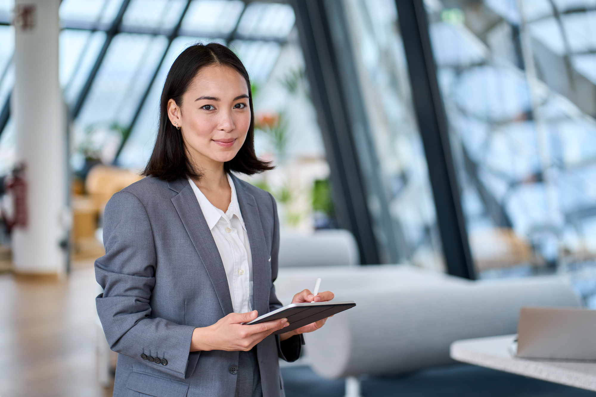 A female solicitor holding a tablet