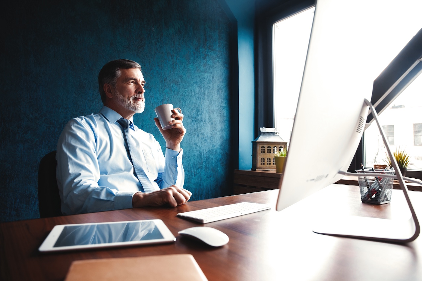 A businessman looking at a computer in an office