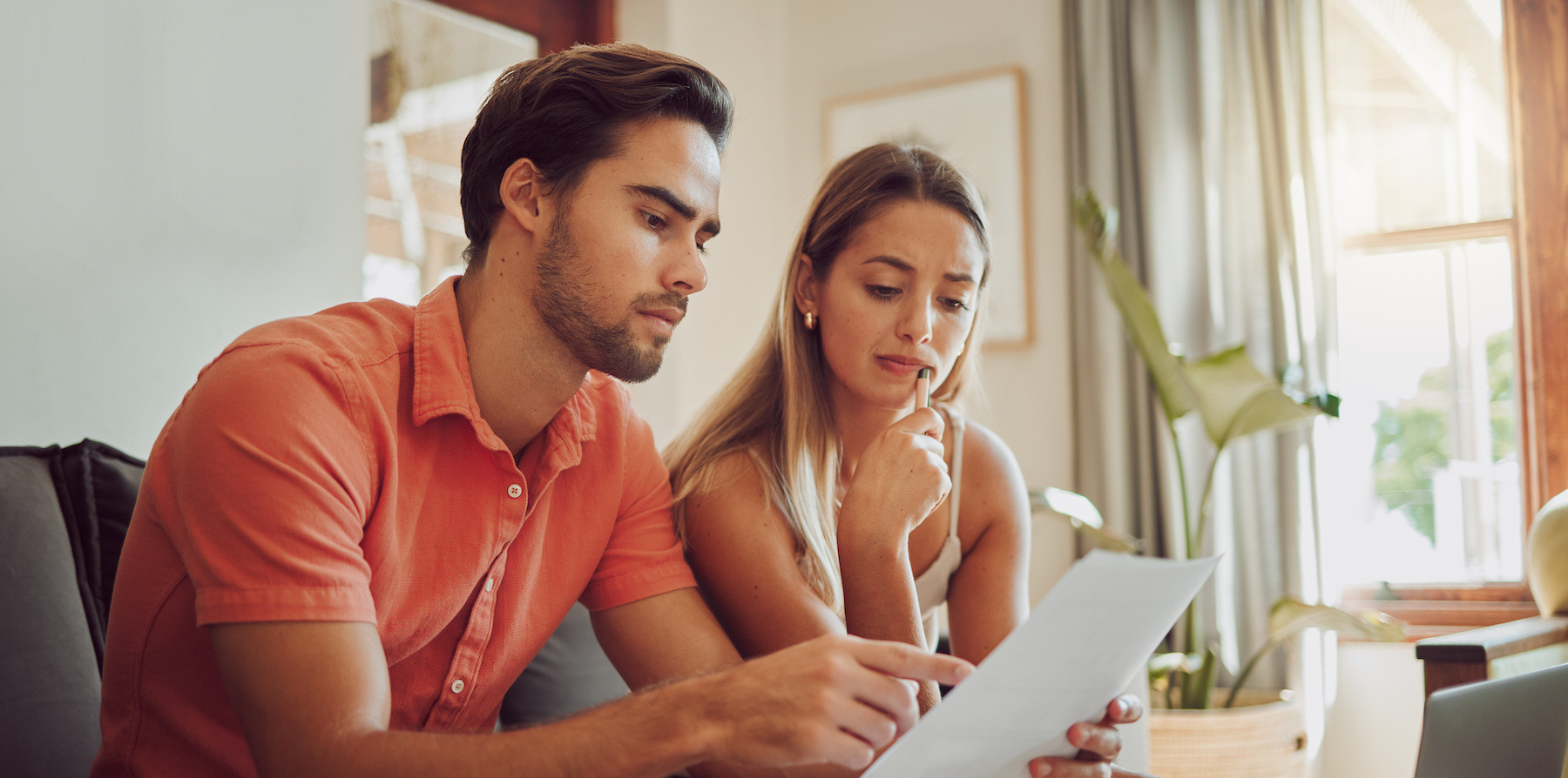 Worried couple looking at papers