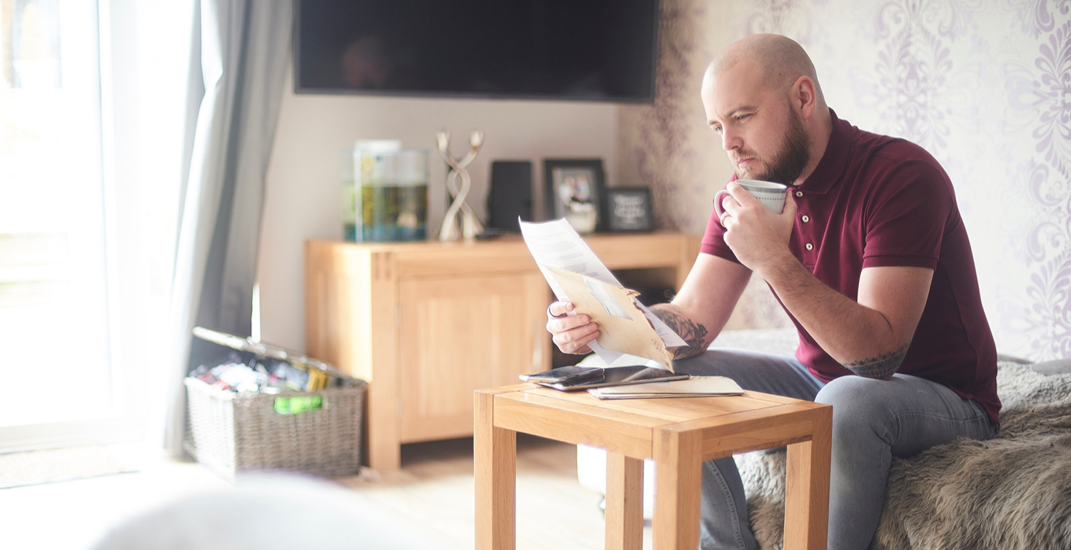 Man looking at documents at home