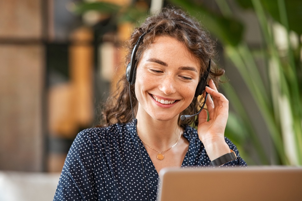 Woman at computer on phone