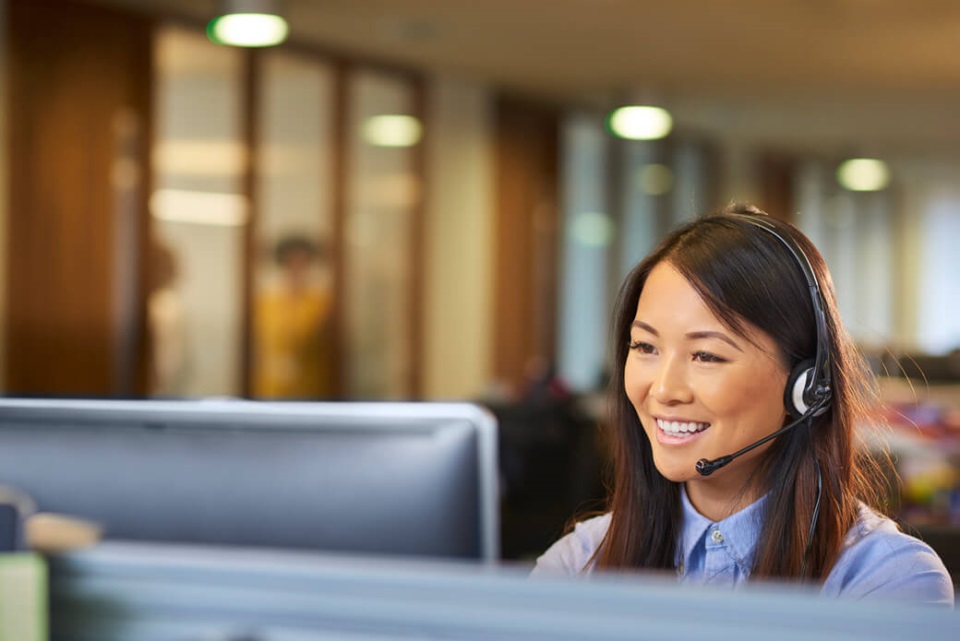 A young call centre representative talking on the phone